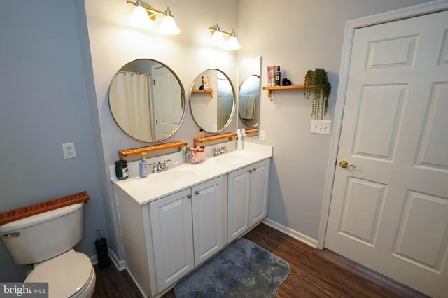a bathroom with a toilet sink and mirror