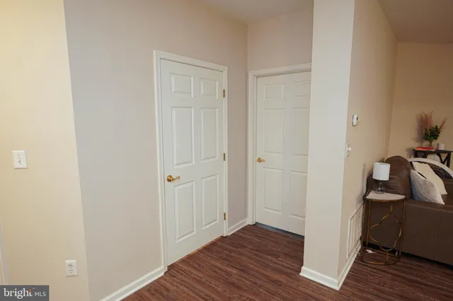 a view of hallway with wooden floor