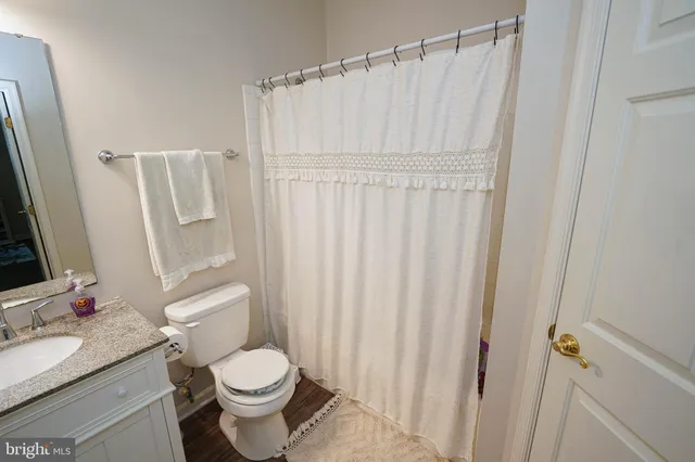 a white toilet sitting next to a bathroom sink