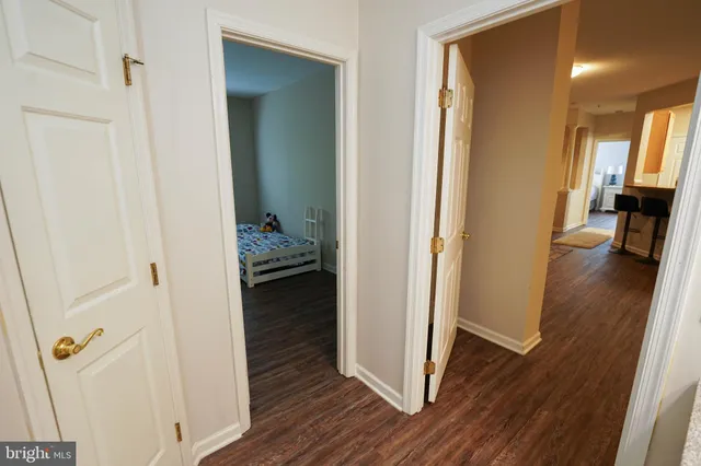 a view of a hallway and wooden floor and a livingroom