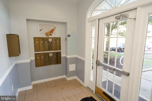 a view of an entryway with wooden floor and door
