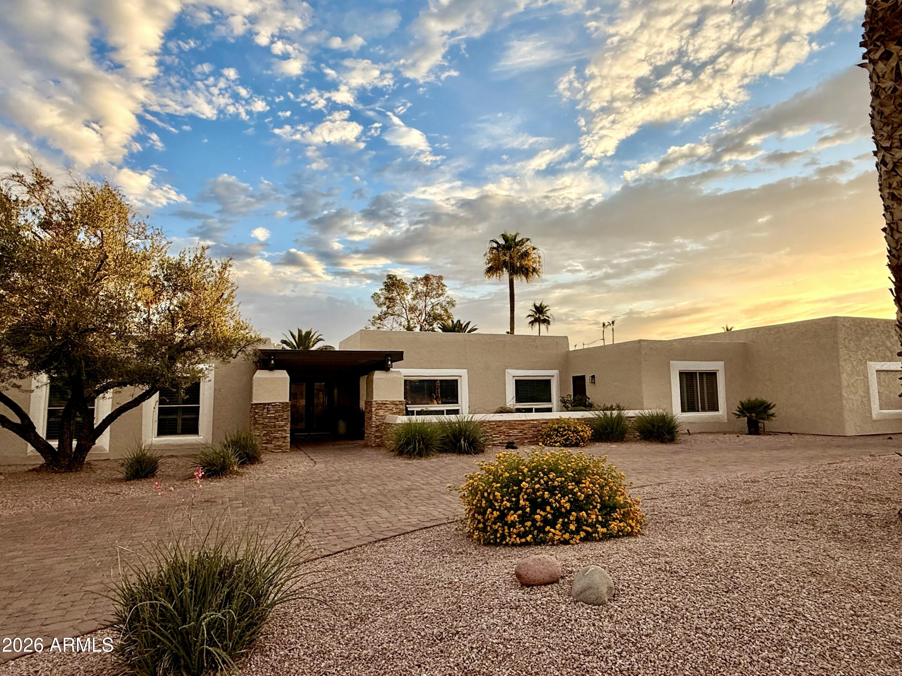6932 East Presidio Road Scottsdale, AZ 85254 - Photo 27 of 30 a front view of a house with a yard