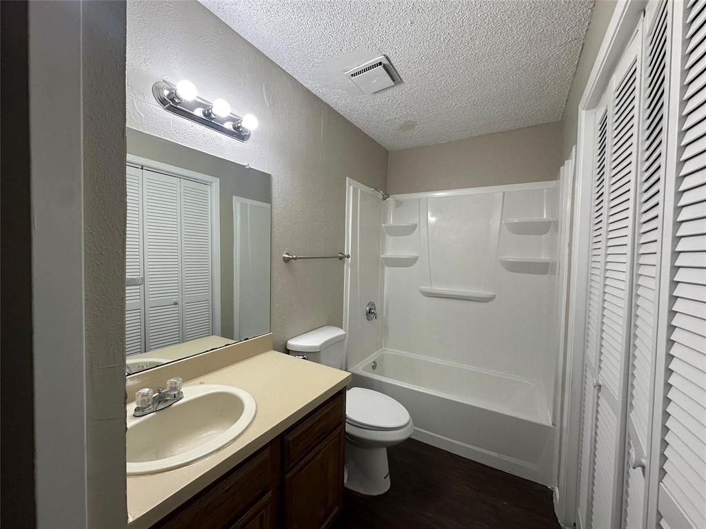 9696 Walnut Street, Unit 1107 Dallas, TX 75243 - Photo 6 of 13 a bathroom with a sink a toilet and shower