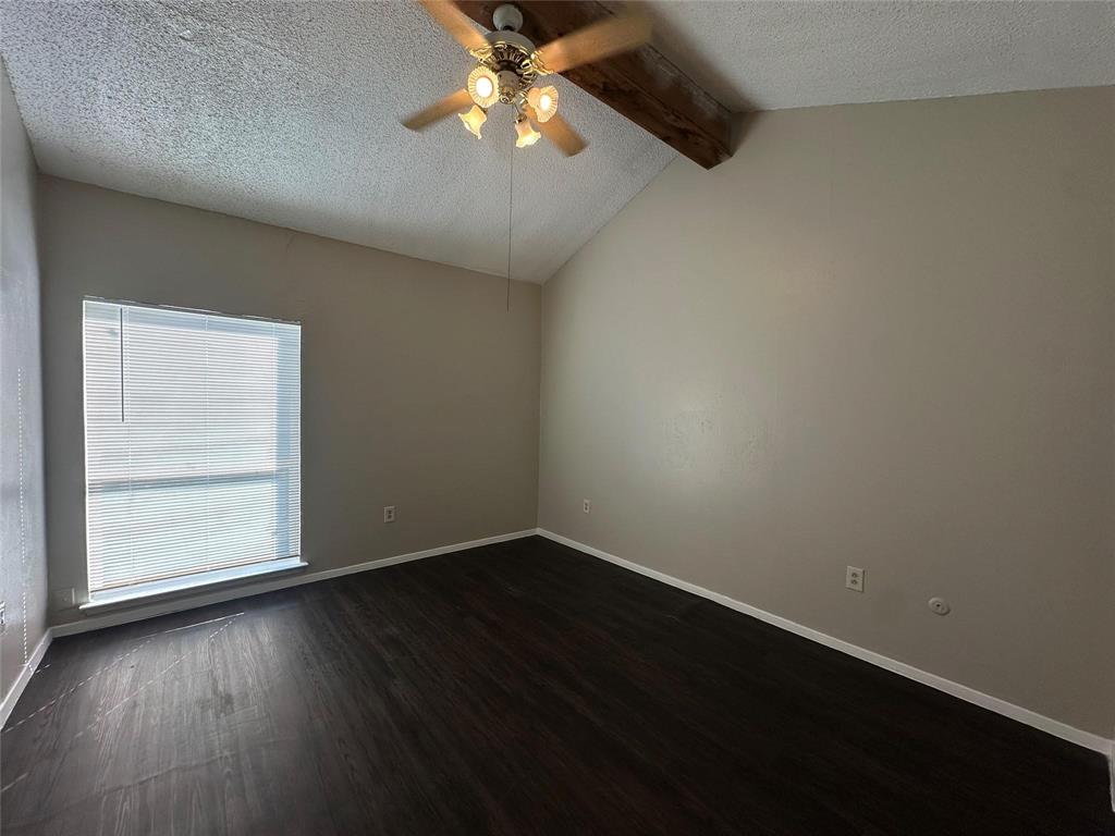 9696 Walnut Street, Unit 1107 Dallas, TX 75243 - Photo 8 of 13 an empty room with wooden floor chandelier fan and windows