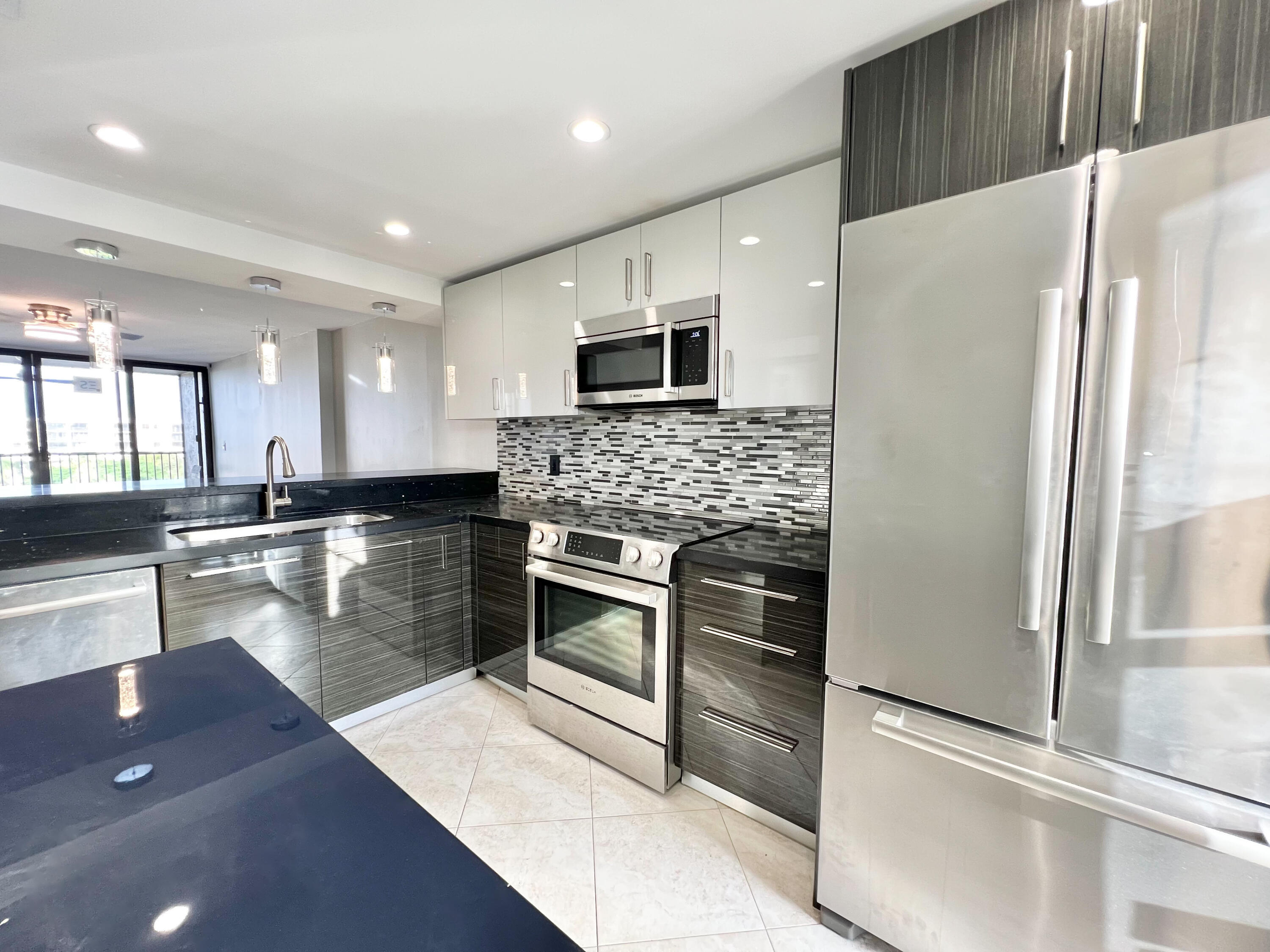 a kitchen with stainless steel appliances granite countertop a refrigerator and a stove