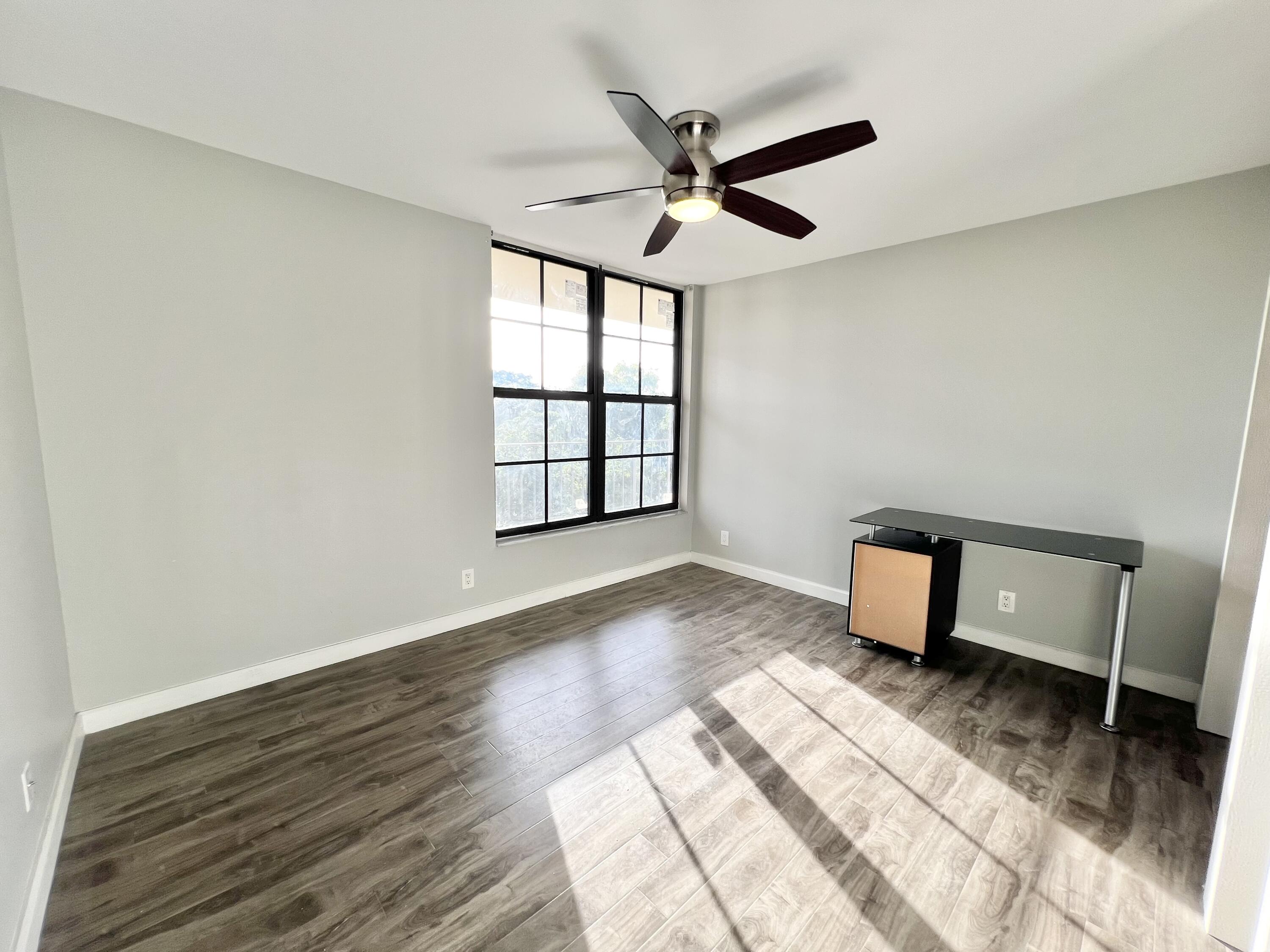 17 Royal Palm Way, Unit 503 Boca Raton, FL 33432 - Photo 14 of 29 a view of a livingroom with a hardwood floor and a ceiling fan