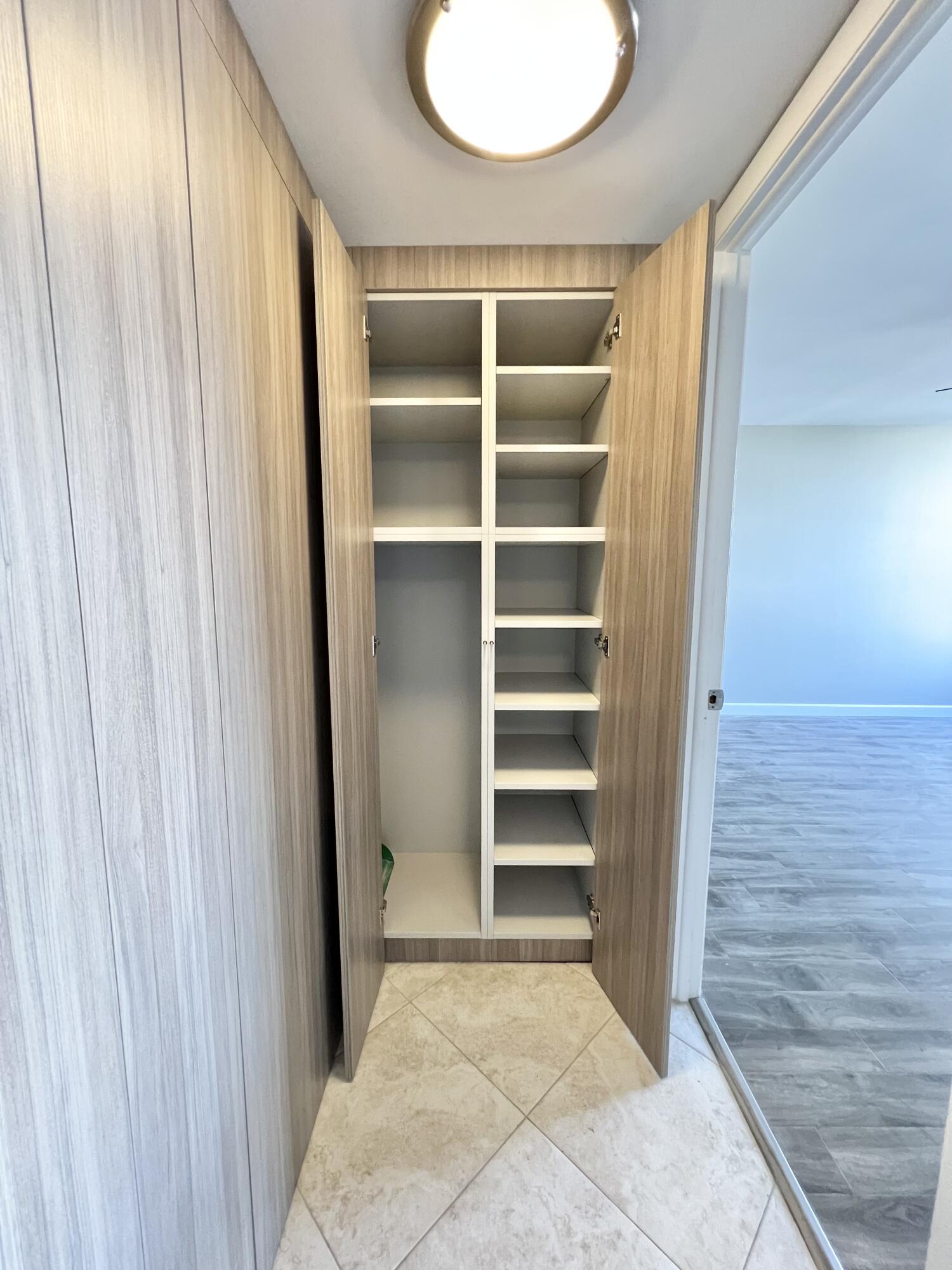 17 Royal Palm Way, Unit 503 Boca Raton, FL 33432 - Photo 10 of 29 a view of walk in closet with empty racks