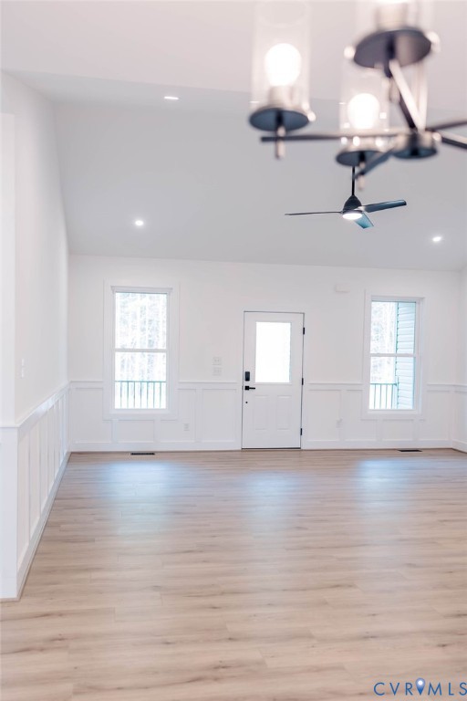 157 Barringer Lane Bumpass, VA 23024 - Photo 13 of 65 an empty room with wooden floor ceiling fan and windows
