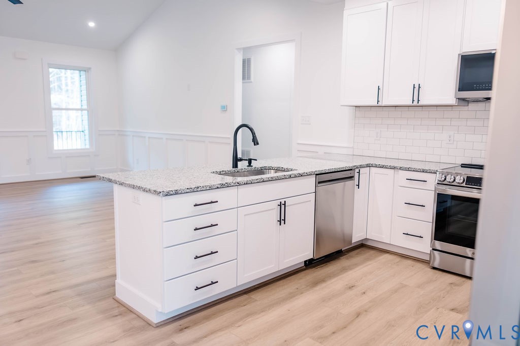157 Barringer Lane Bumpass, VA 23024 - Photo 10 of 65 a kitchen with cabinets appliances a sink and a window