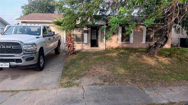 a front view of a house with parking space