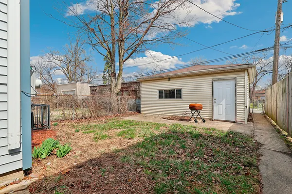 a backyard of a house with table and chairs