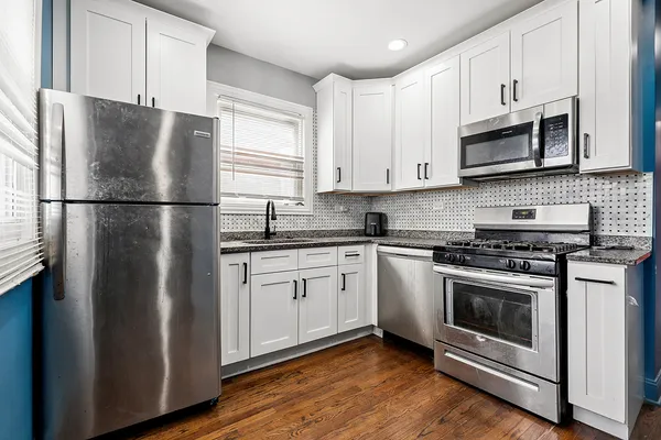 a kitchen with stainless steel appliances a refrigerator stove and microwave