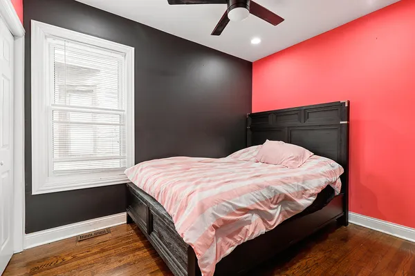 a bed sitting in a bedroom next to a window