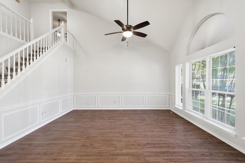 318 Lodge Road Coppell, TX 75019 - Photo 8 of 35 A sweeping staircase and dramatic ceiling height bring architectural interest to this bright and versatile living space.