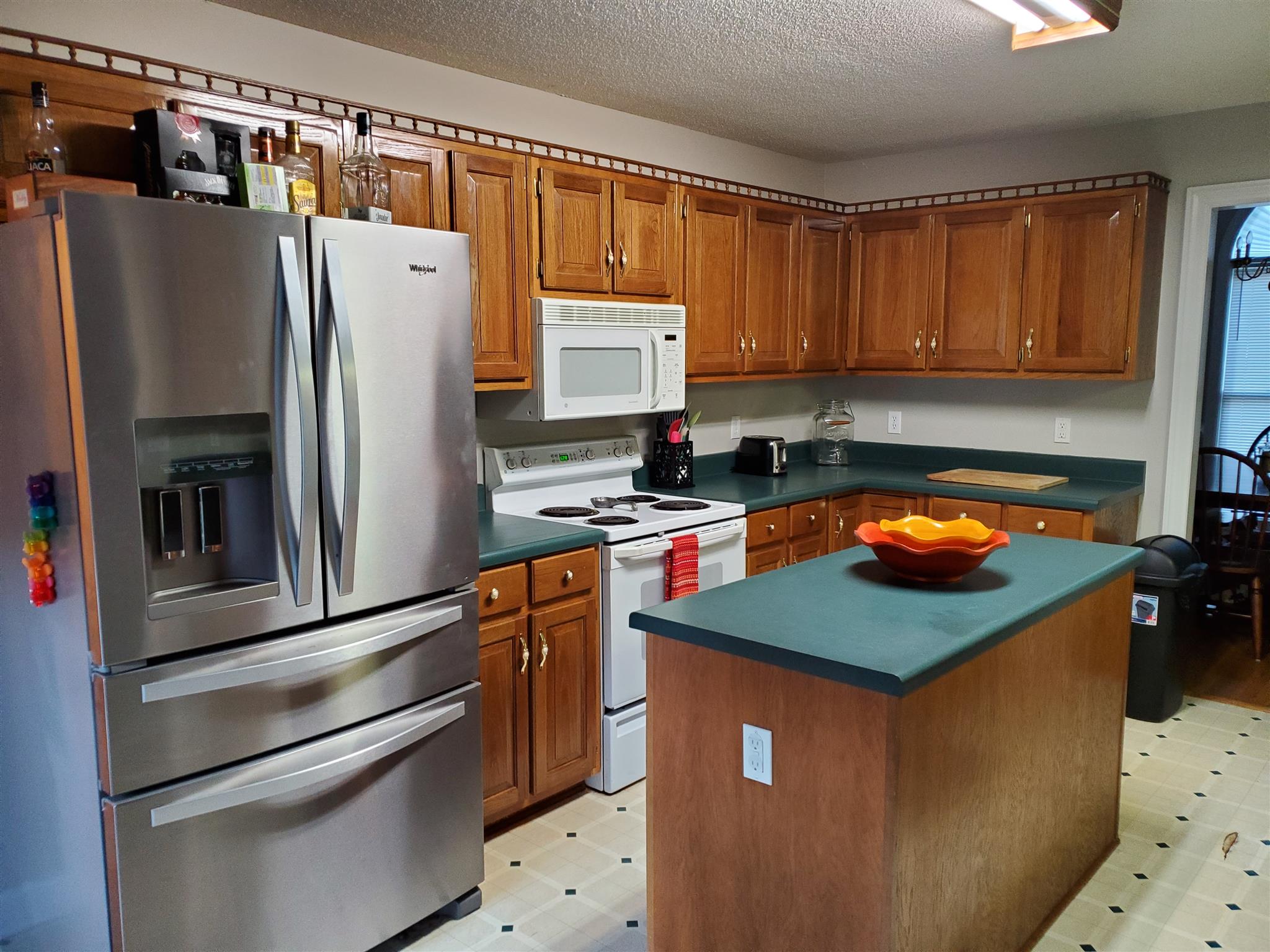 75 Eastridge Road Fayetteville, TN 37334 - Photo 9 of 25 a kitchen with stainless steel appliances a refrigerator and a stove top oven