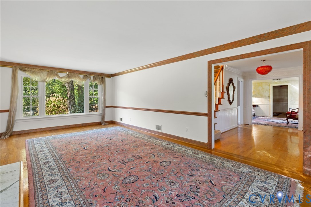 5212 Beddington Road Richmond, VA 23234 - Photo 5 of 22 a view of empty room with floor to ceiling window and wooden floor