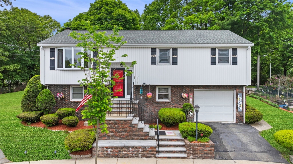 a front view of a house with garden