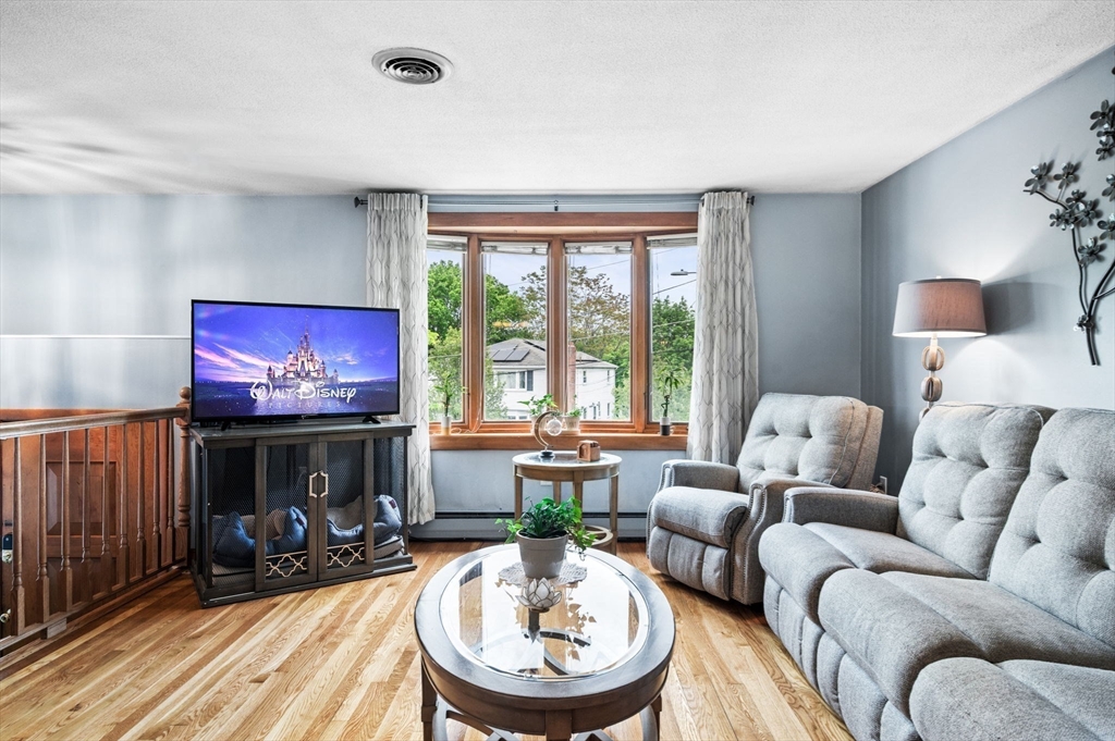 30 Lanark Road Malden, MA 02148 - Photo 12 of 40 a living room with furniture a fireplace and a flat screen tv