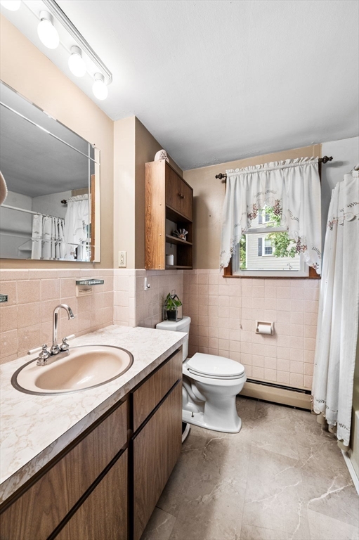 30 Lanark Road Malden, MA 02148 - Photo 24 of 40 a bathroom with a sink a toilet and a mirror