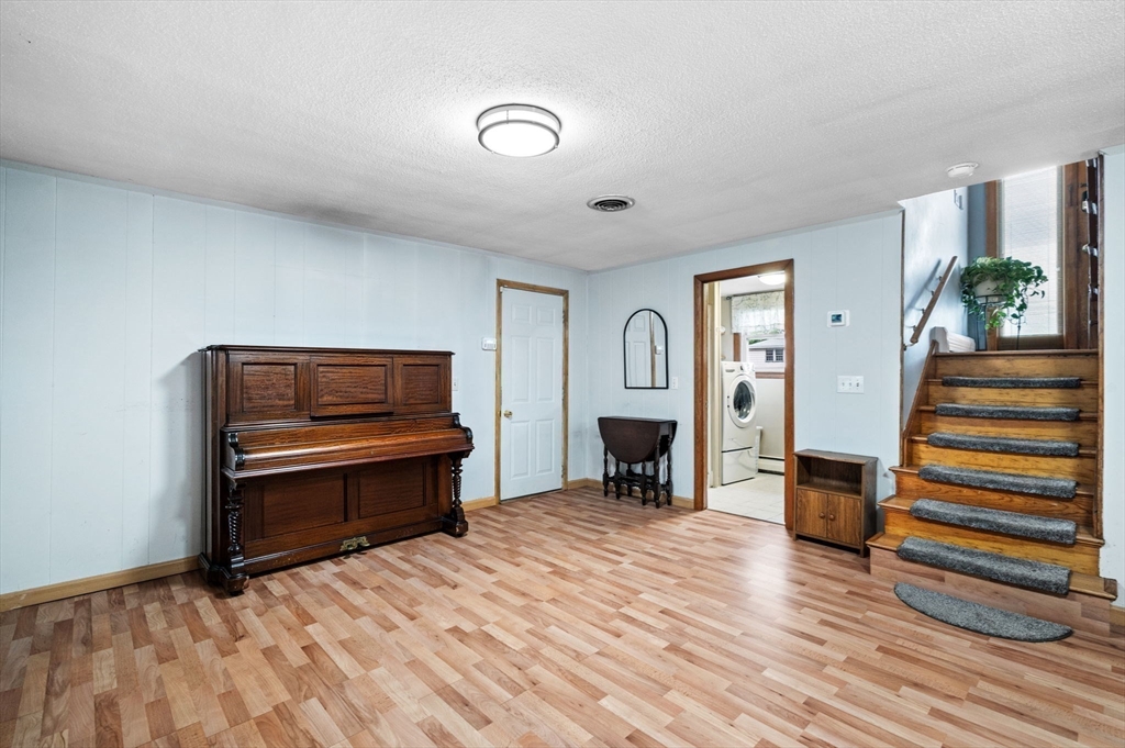 30 Lanark Road Malden, MA 02148 - Photo 29 of 40 a living room with furniture a fireplace and a flat screen tv