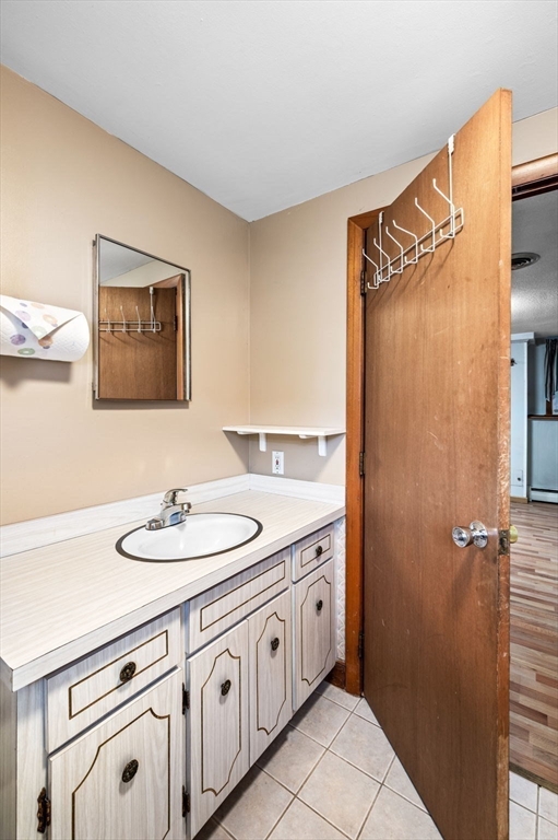30 Lanark Road Malden, MA 02148 - Photo 30 of 40 a bathroom with a double vanity sink and a mirror