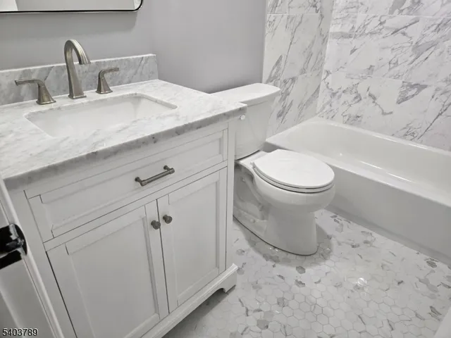 a bathroom with a toilet sink and bathtub