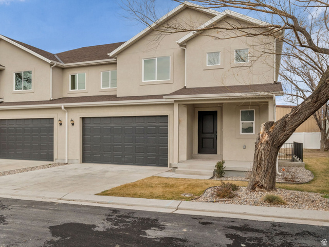 576 7th Avenue Midvale, UT 84047 - Photo 1 of 32 Traditional home featuring covered porch, driveway, stucco siding, and an attached garage