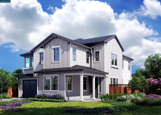 a view of a white house with a big yard and potted plants