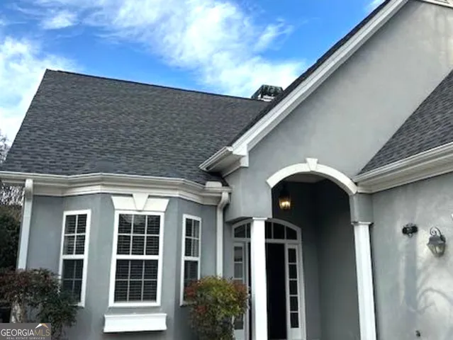 a view of a kitchen with a sink hardwood floor and a large window