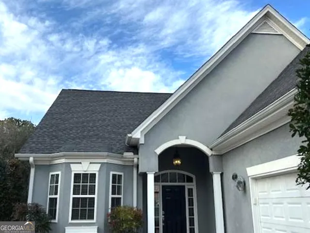 a living room with a fireplace and a painting on the wall
