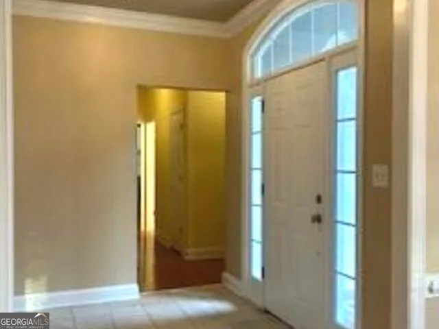 a view of kitchen with granite countertop cabinets and refrigerator