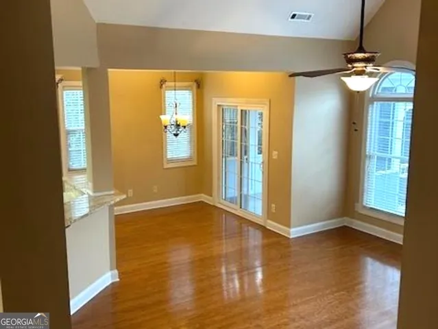 a kitchen with granite countertop white cabinets and stainless steel appliances