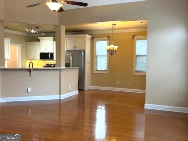 a kitchen with stainless steel appliances granite countertop a sink and a stove