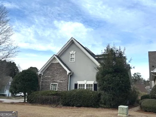 a view of a house with a tree