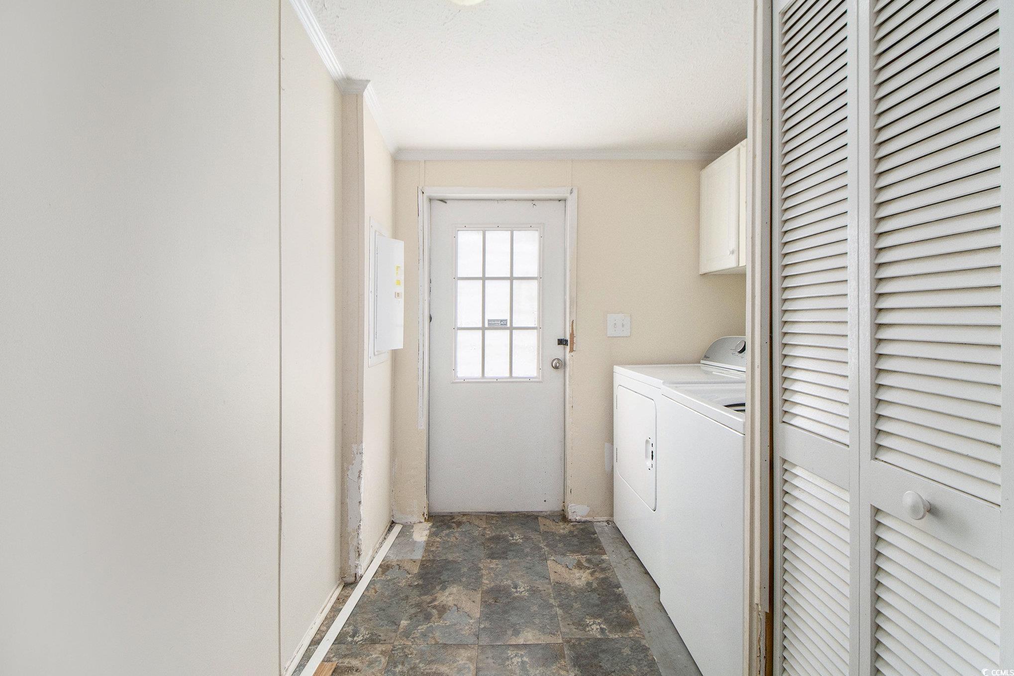 3804 Stern Drive Conway, SC 29526 - Photo 17 of 38 Laundry room featuring stone finish floors, cabinet space, independent washer and dryer, electric panel, and crown molding