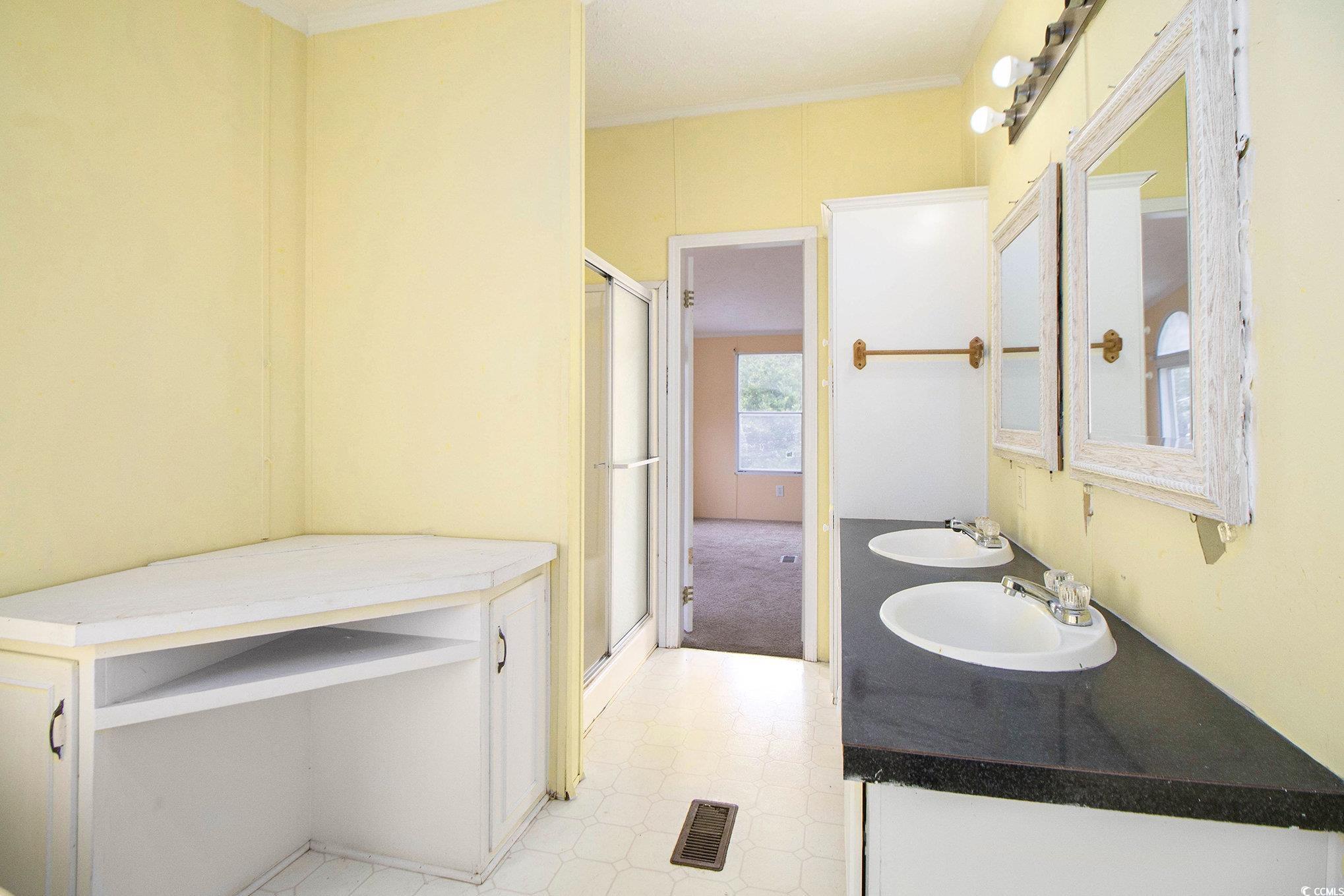 3804 Stern Drive Conway, SC 29526 - Photo 23 of 38 Full bathroom with double vanity, a shower stall, light floors, and crown molding