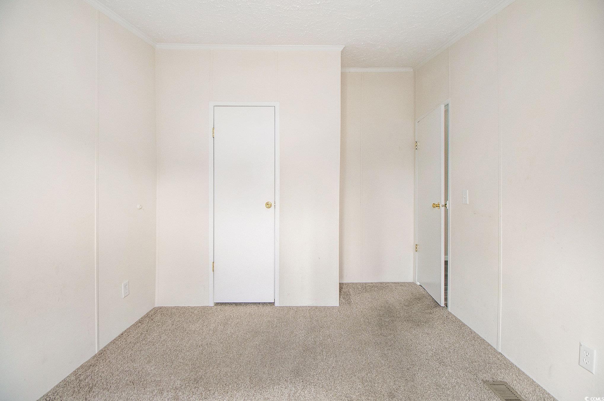 3804 Stern Drive Conway, SC 29526 - Photo 27 of 38 Carpeted spare room featuring a textured ceiling and crown molding