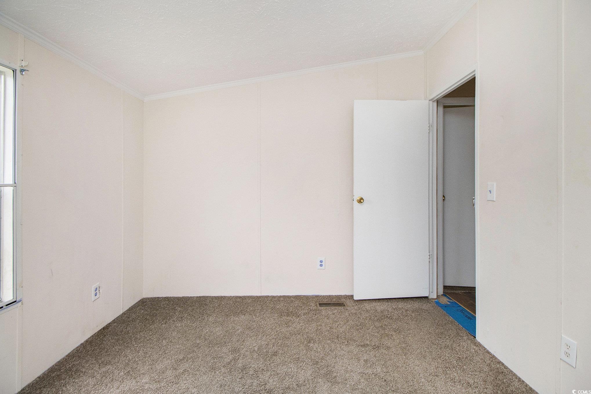 3804 Stern Drive Conway, SC 29526 - Photo 30 of 38 Carpeted empty room featuring ornamental molding and a textured ceiling