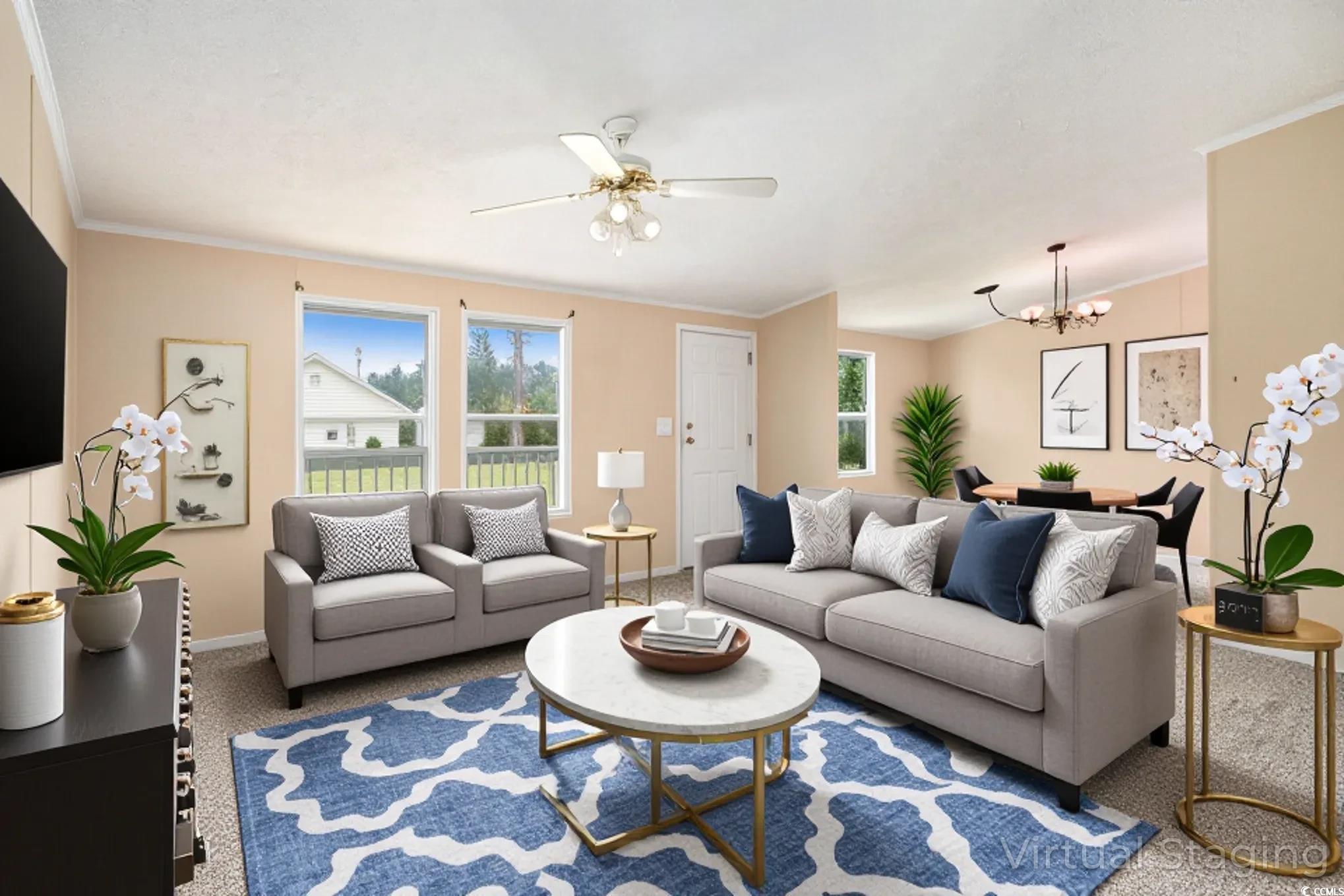 3804 Stern Drive Conway, SC 29526 - Photo 6 of 38 Living area with ornamental molding, carpet flooring, a ceiling fan, and a chandelier