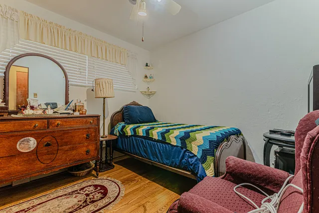 a bedroom with furniture and wooden floor