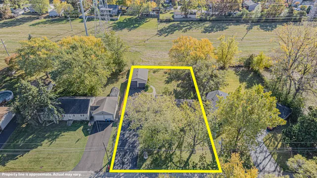 an aerial view of residential houses with outdoor space and lake view