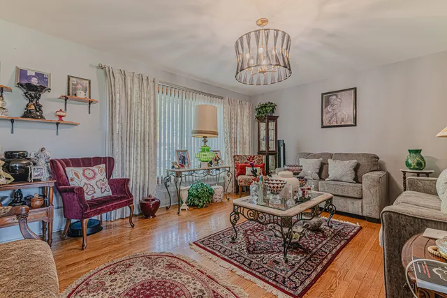 a living room with furniture or couch and a chandelier