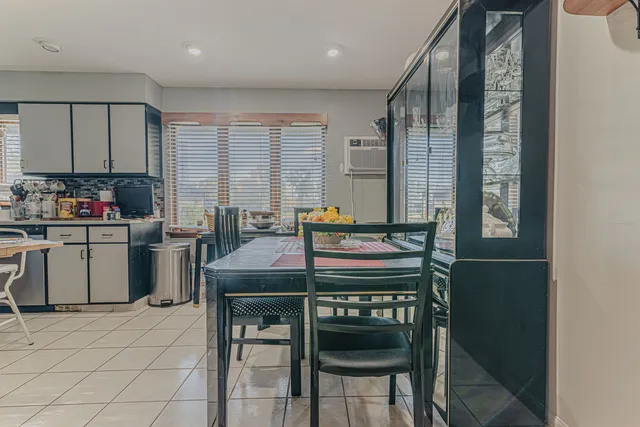a kitchen with a table chairs stove and cabinets
