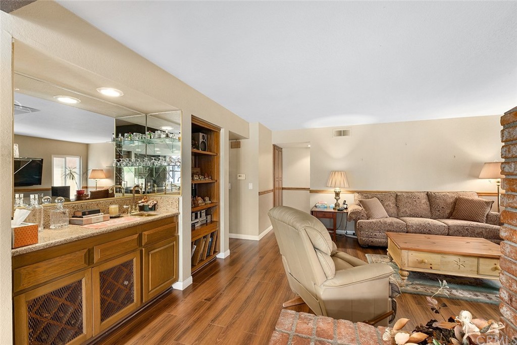 3 Descanso Irvine, CA 92620 - Photo 17 of 54 a large living room with stainless steel appliances kitchen island granite countertop a couch and a view of living room