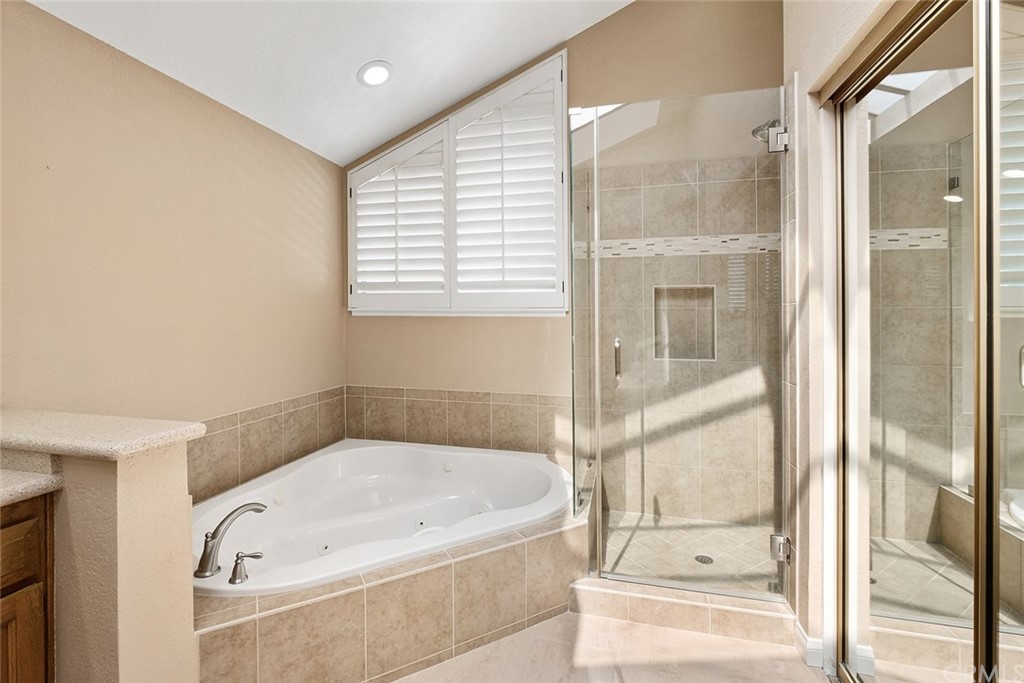 3 Descanso Irvine, CA 92620 - Photo 29 of 54 a bathroom with a bathtub and a shower