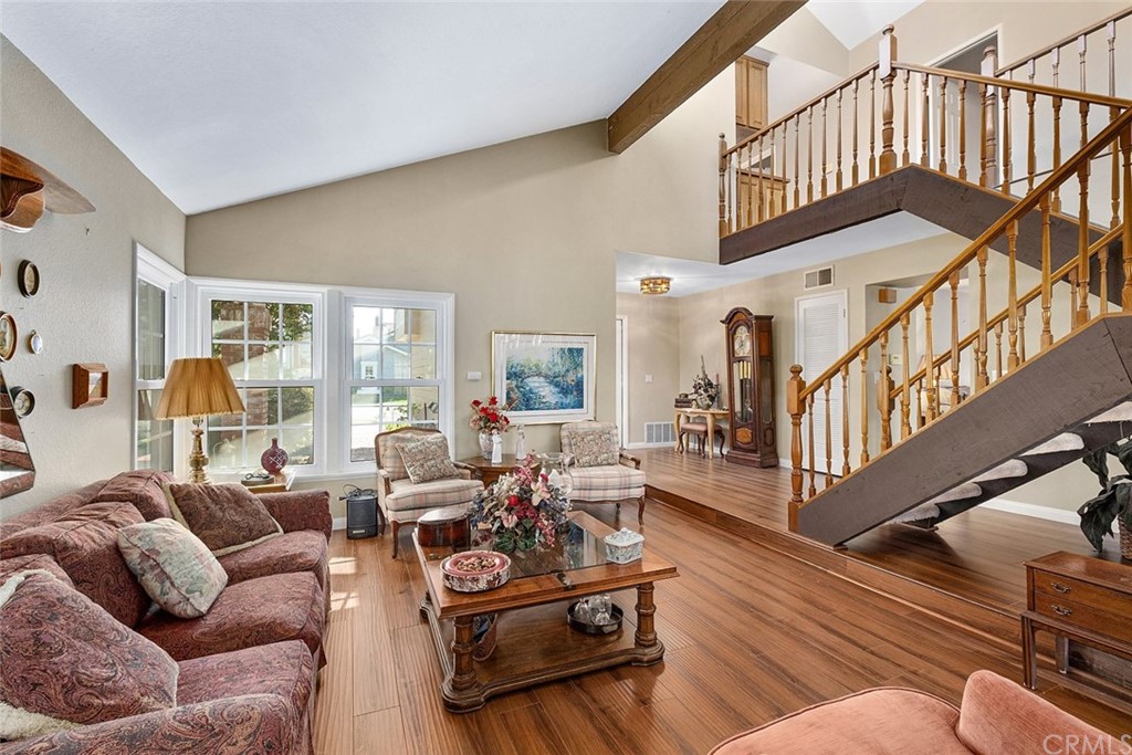 3 Descanso Irvine, CA 92620 - Photo 8 of 54 a living room with furniture stairs and a wooden floor