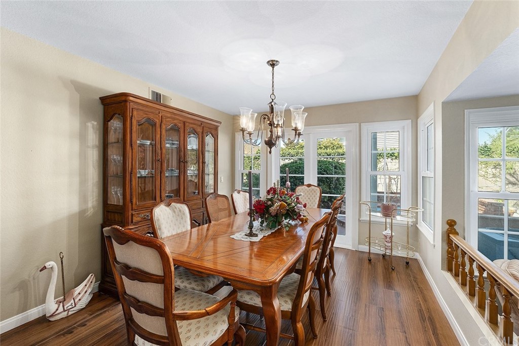 3 Descanso Irvine, CA 92620 - Photo 10 of 54 a dining room with furniture a chandelier and wooden floor