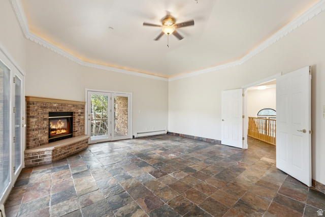 3535 Homestead Road Park City, UT 84098 - Photo 29 of 81 Spacious room featuring slate tile flooring, a corner brick fireplace, and dual French doors leading to exterior access