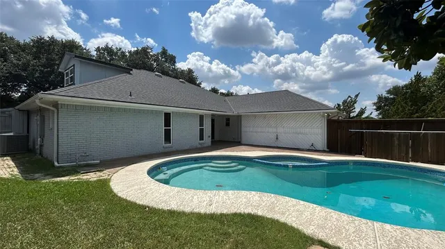 a swimming pool with outdoor seating and yard