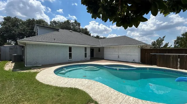 a view of swimming pool with a patio
